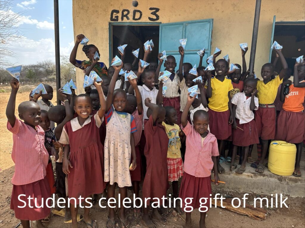 Students celebrating gift of milk Students celebrating gift of milk